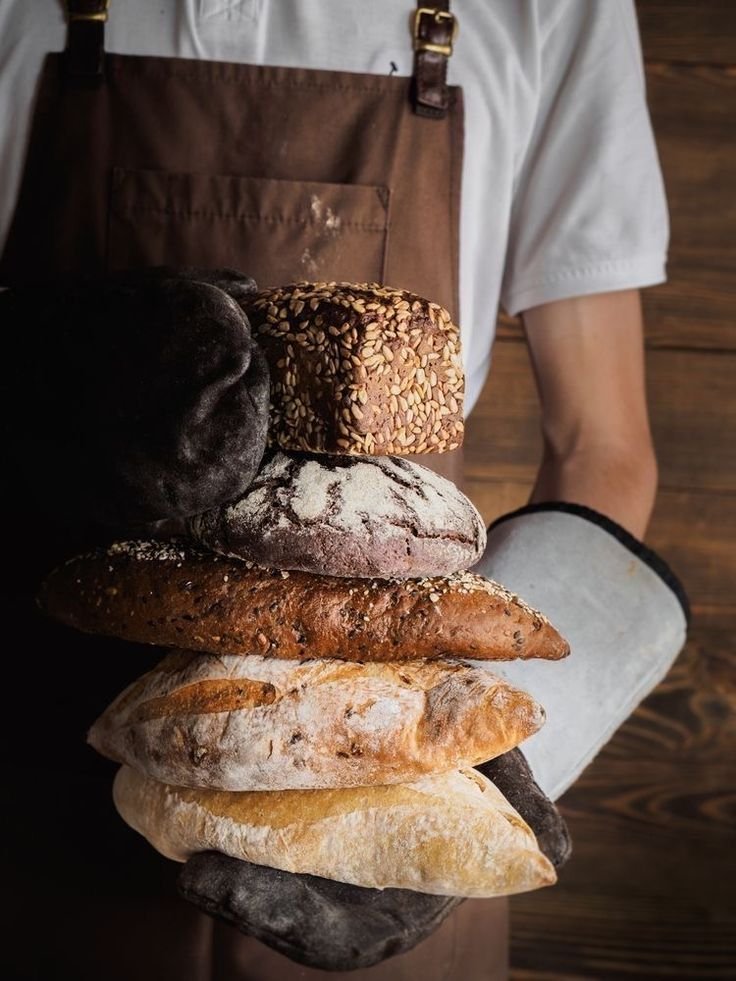 Stack of assorted breads made with dry yeast, showcasing different textures and crusts